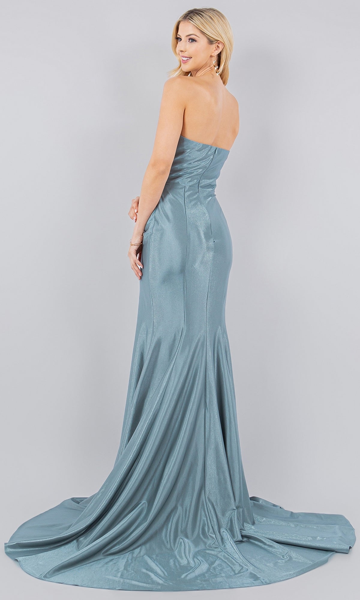 A woman poses in the Cinderella Couture 8083J Satin Mermaid Prom Dress, a strapless light blue gown with a small train, set against a plain light gray background.